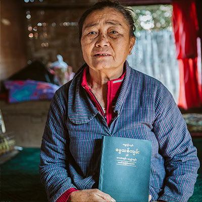 Woman inside holding a Bible
