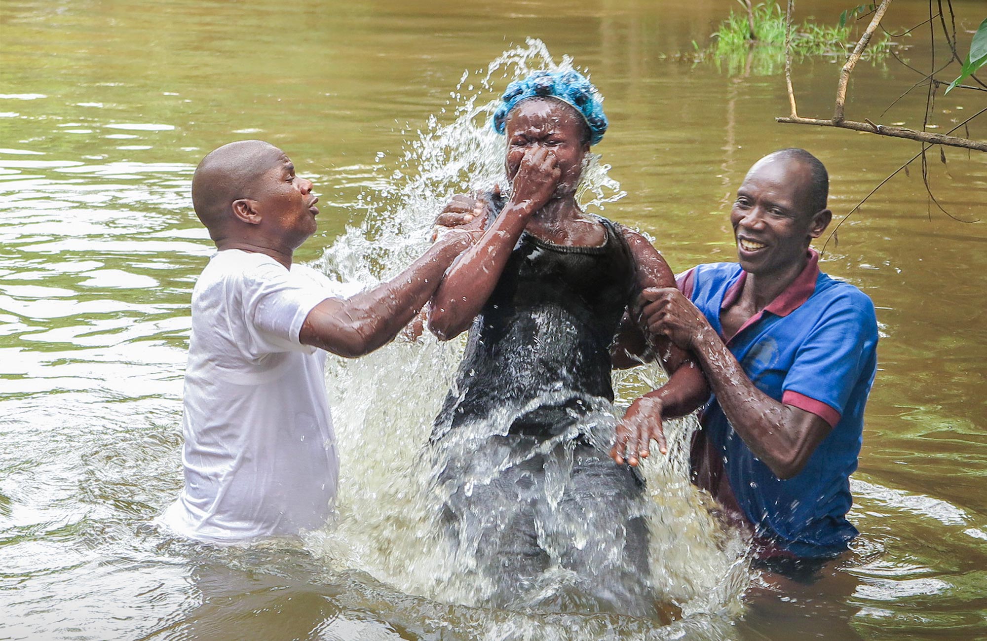 Woman being baptized in a river